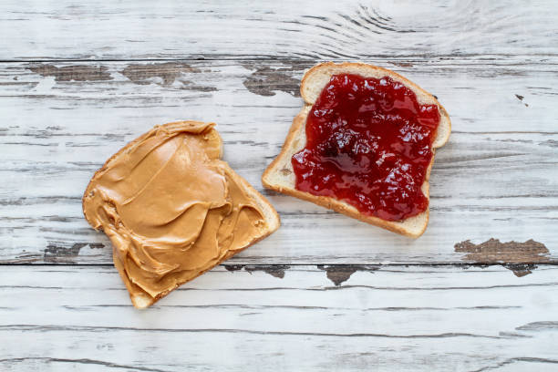 istock Open Peanut Butter and Strawberry Jelly Sandwich 1138833480
