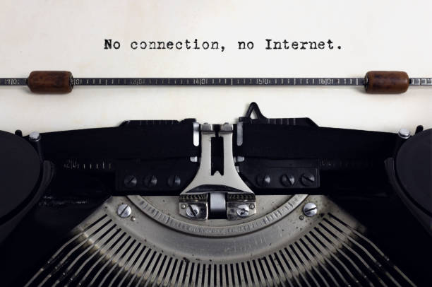 istock Old retro vintage black typewriter with close-up typing text No connection, no Internet as heading on aged paper 1138834187