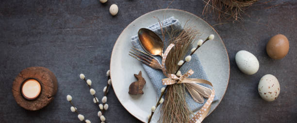 easter place setting on dark table plate - retro revival food easter napkin imagens e fotografias de stock