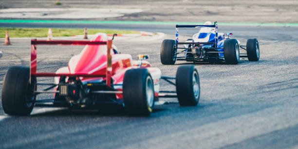 istock Rear view of two formula race cars on the track 1138834708