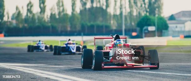 Three Formula Race Cars On The Race Track Stock Photo - Download Image Now - Racecar, Auto Racing, Sports Race