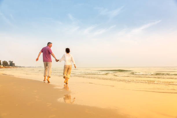 istock Senior Couple Enjoying Beach Holiday 1138835394