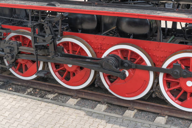 istock Old steam train wheels approaching, close-up. Black and red wheels. Rails and sleepers. 1138837554