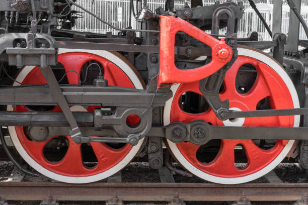 istock Old steam train wheels approaching, close-up. Black and red wheels. Rails and sleepers. 1138837577
