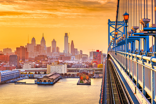 Philadelphia, Pennsylvania, USA downtown skyline from the Benjamin Franklin Bridge at twilight.