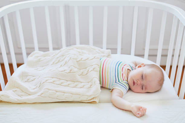istock Baby sleeping in co-sleeper crib attached to parents' bed 1138839189