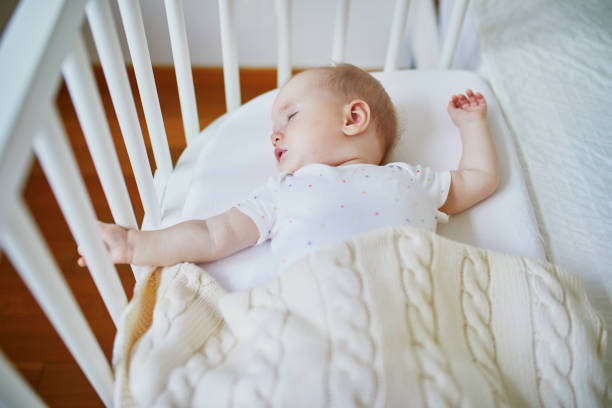 istock Baby sleeping in co-sleeper crib attached to parents' bed 1138839217