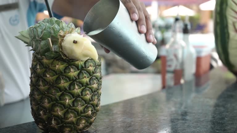 cocktail is poured into pineapple