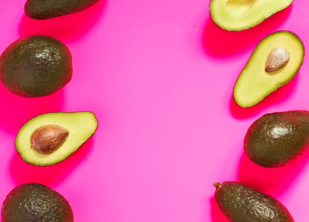 istock Fresh Avocado on Vibrant Pink background. Top view, flat lay, copy space. Banner. 1138842733