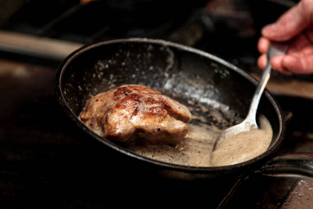 Steak in frying pan stock photo