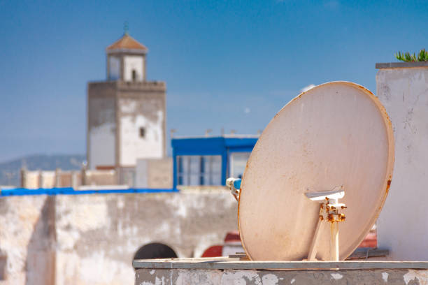 Satellite dish on the roof of old moroccan building stock photo
