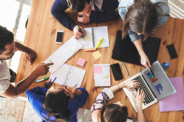 istock overhead view on business people around desk 1138843871