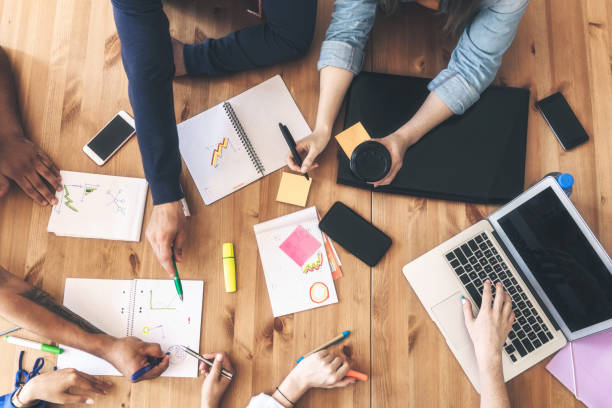 istock overhead view on business people around desk 1138843988