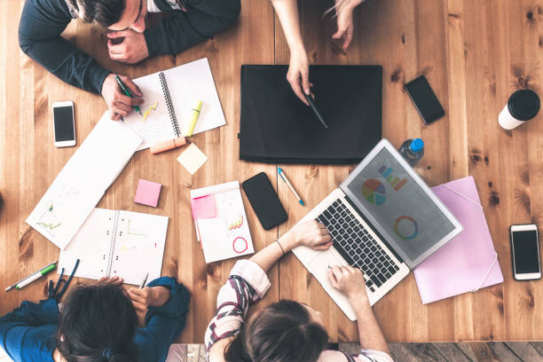 istock overhead view on business people around desk 1138844016