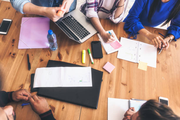 istock overhead view on business people around desk 1138844075