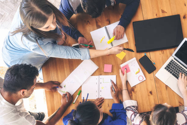 istock overhead view on business people around desk 1138844136