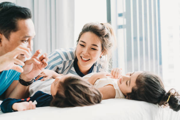 istock Happy family on the bed together 1138846122