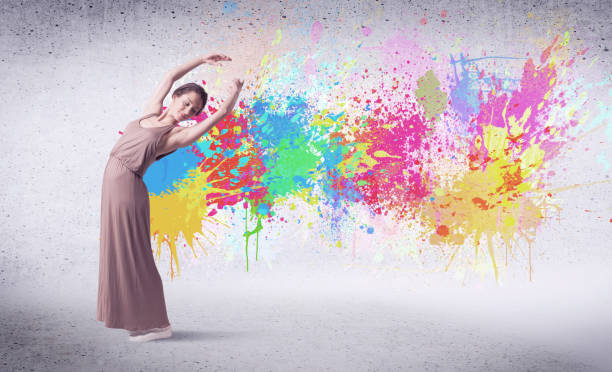 istock Modern street dancer jumping with colorful paint splashes 1138846349