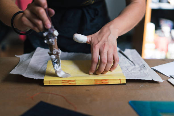 Young adult woman making a notebook