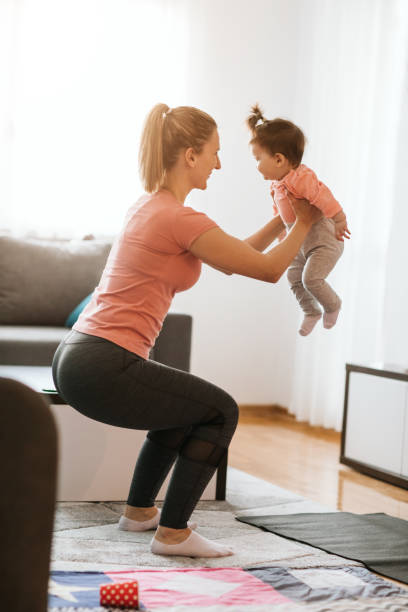 istock Young Mother Exercising At Home With Her Baby 1138849166