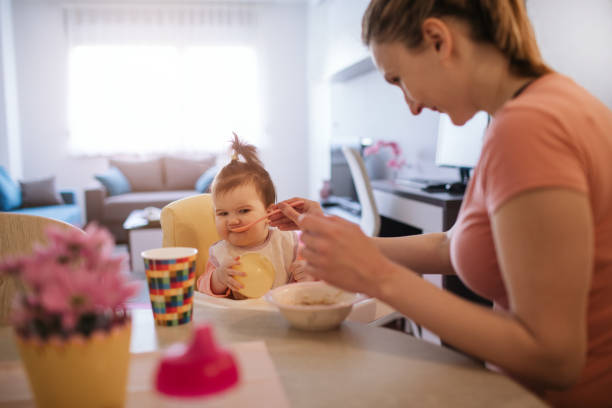 istock Young Mother Feeding Her Baby 1138849207