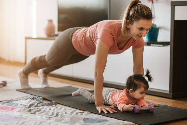 istock Young Mother Exercising At Home With Her Baby 1138849244