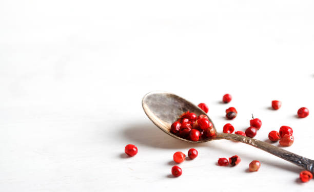 istock Pink peppers in spoon, copy space 1138850713