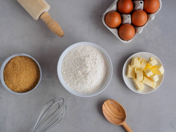istock Baking Ingredients, Flour, Sugar and Butter on a grey Background, Top View 1138850934