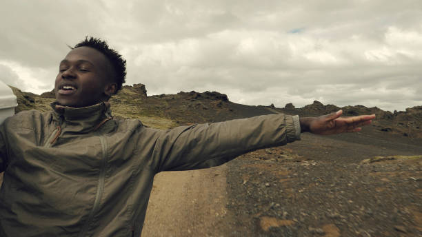 On the road trip. African man in enjoying the journey.