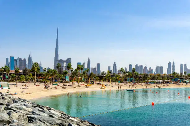 Photo of Beach in Dubai with people and skyscapers in the background