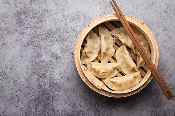 istock Asian dumplings in bamboo steamer 1138852973