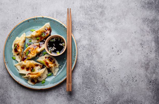 istock Asian dumplings in bamboo steamer 1138852977