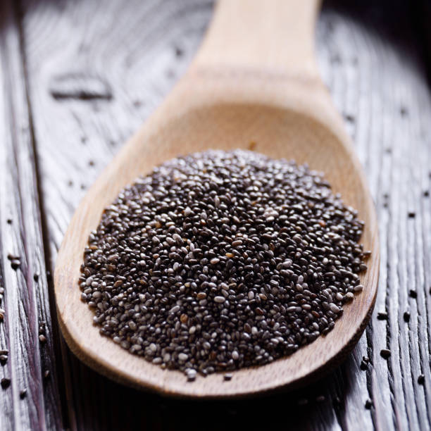 istock Raw Chia seeds in bamboo spatula on wooden table 1138853979
