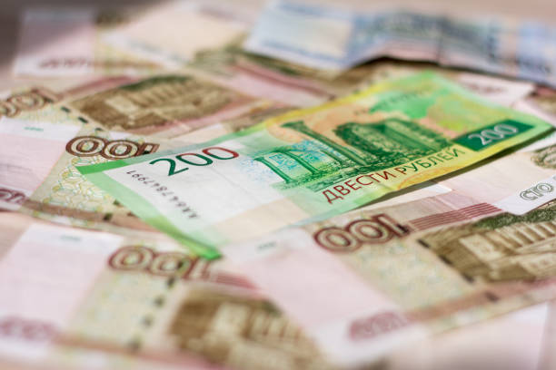 istock money background, Russian hundred-ruble and two-ruble bills in a mess lying on the table 1138857614
