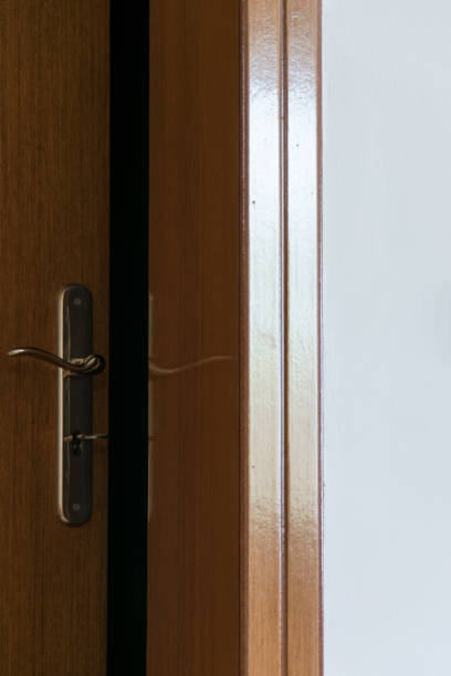 istock Crop view of half-open door. Security. Privacy concept 1138857727