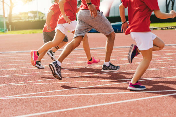 istock Low section view of runner's feet running on racing track 1138859060