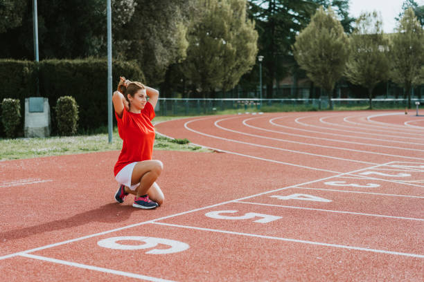 istock One female runner crouching at starting blocks 1138859109