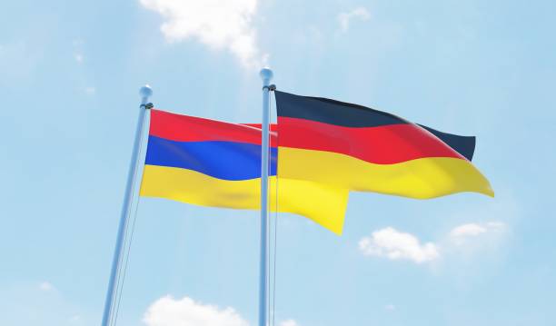 istock Germany and Armenia, two flags waving against blue sky 1138859545