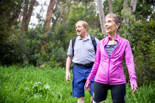 istock Senior Couple Hiking in Forest 1138861956