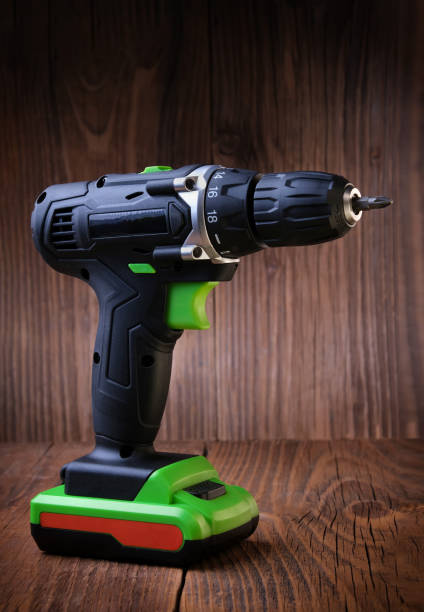 istock Electric screwdriver on rustic wooden background. cordless drill. maintenance home concept. Space for text. 1138863493