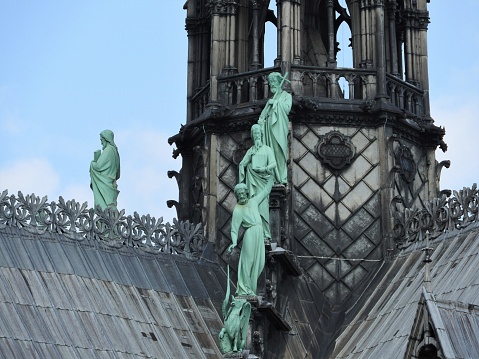 Statues of the apostles on the roof of Notre Dame, the approach of fragments. Paris France, UNESCO world heritage site.