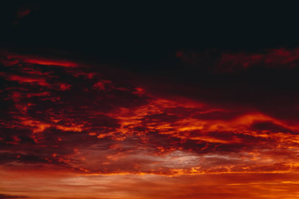 istock Fiery red blood vampire dawn. Amazing warm dramatic fire cloudy sky. Vivid orange sunlight. Atmospheric background of sunrise in overcast weather. Hard cloudiness. Storm clouds warning. Copy space. 1138865045