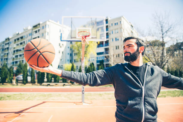 istock Man holding basketball ball 1138866201