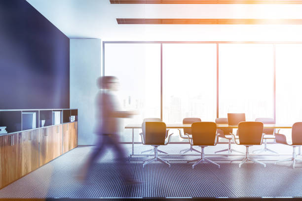 istock Man in black panoramic meeting room interior 1138866251