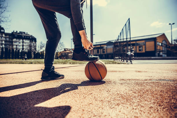 istock Basketball player tying shoelace 1138866253