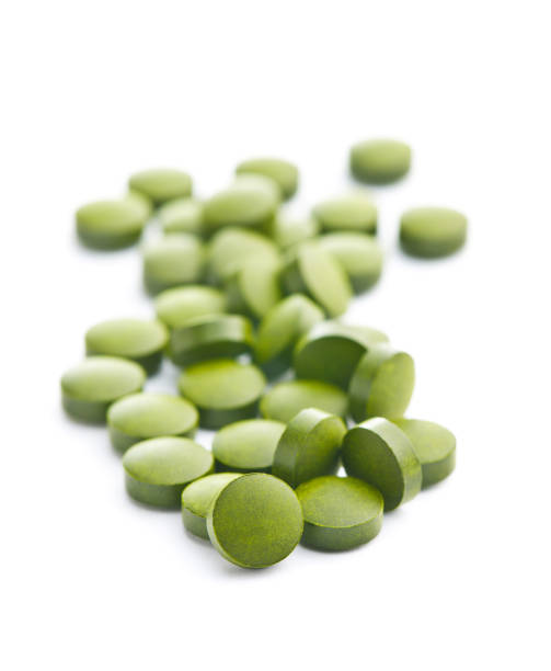 istock Healthy chlorella pills or green barley pills. 1138867602