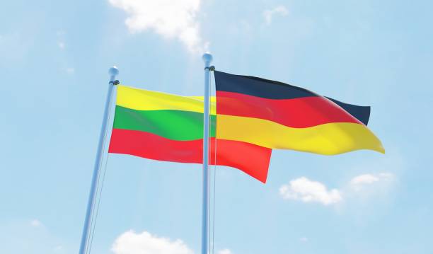 istock Germany and Lithuania, two flags waving against blue sky 1138867920