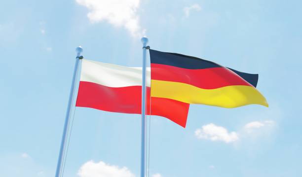 istock Germany and Poland, two flags waving against blue sky 1138868021