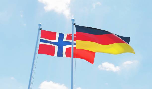 istock Germany and Norway, two flags waving against blue sky 1138868027
