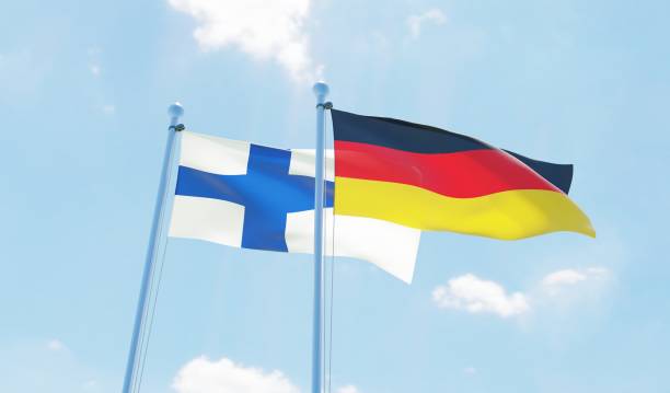 istock Germany and Finland, two flags waving against blue sky 1138868169